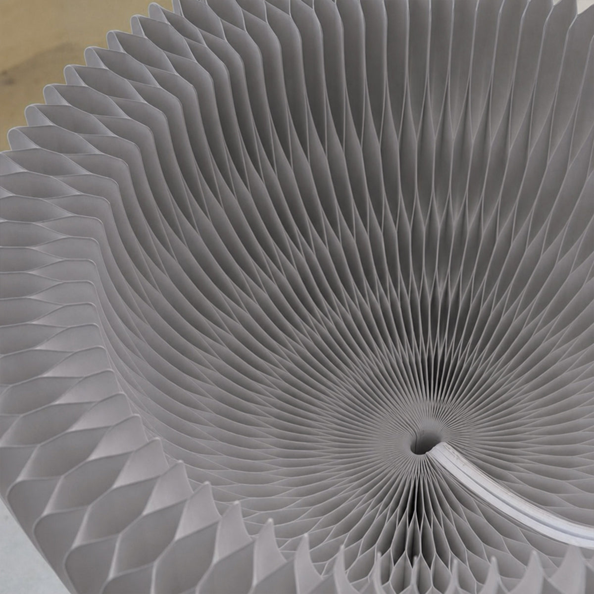 Close-up of the grey Bouquet Side Table A foldable honeycomb paper structure.