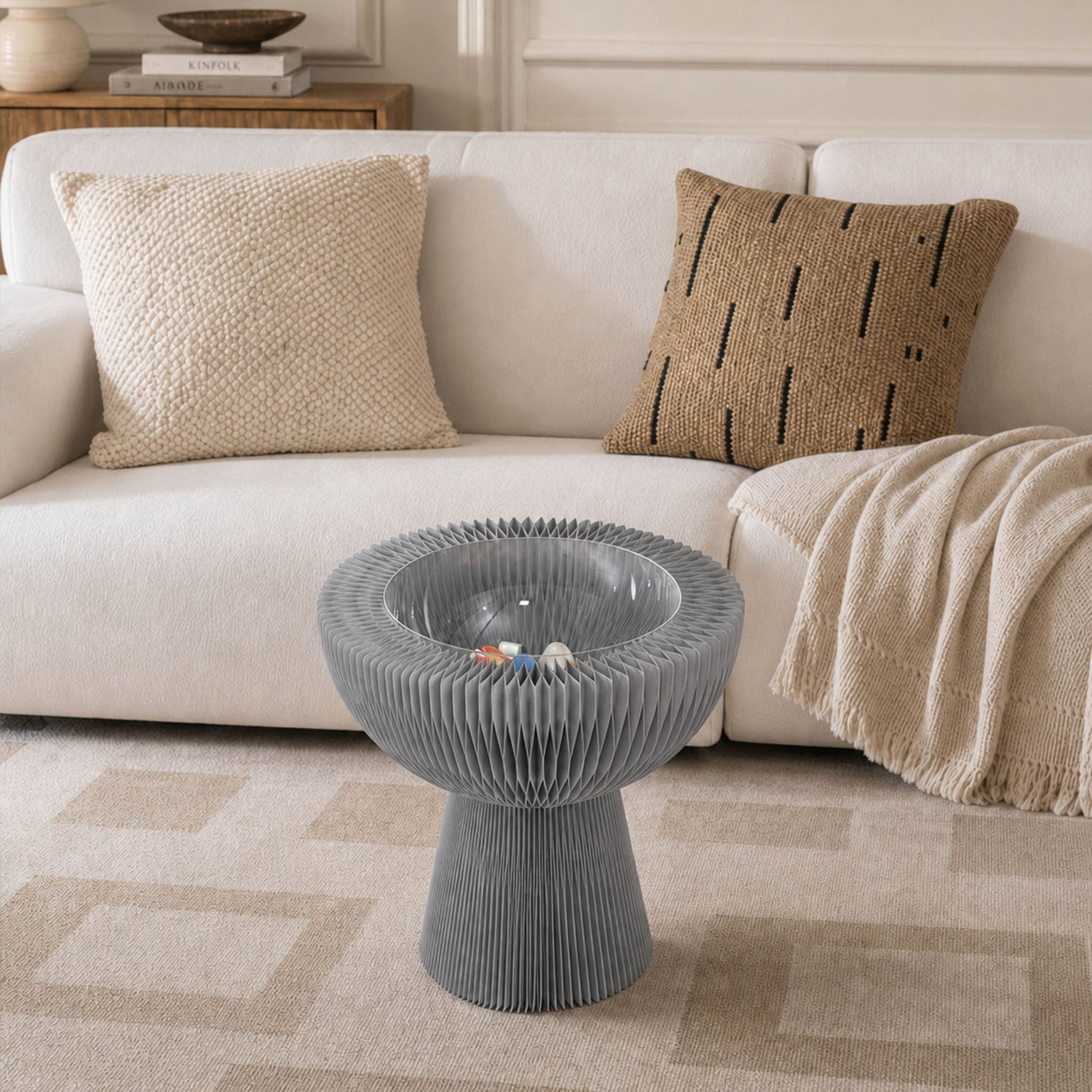 Grey Bouquet Side Table A beside a sofa with its center-hollow storage compartment on display.