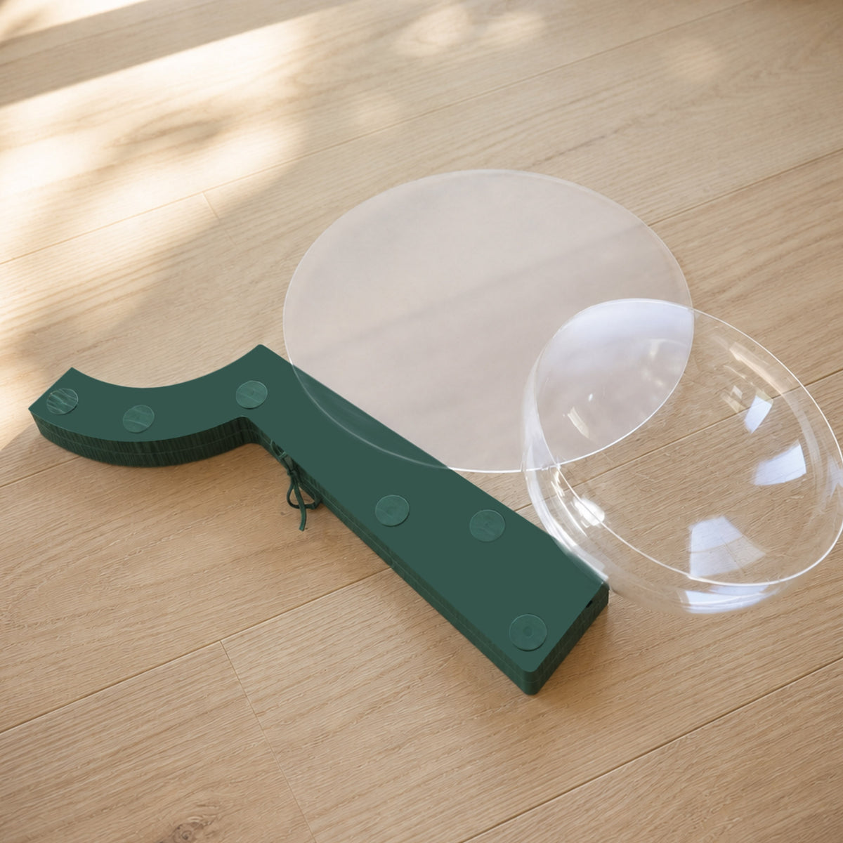 Folded pine green Bouquet Side Table A with acrylic panels and clear dome components for compact storage.