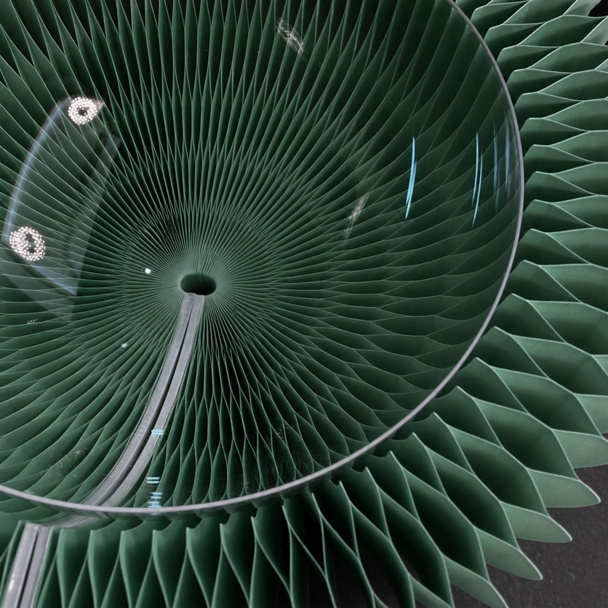 Close-up of the pine green Bouquet Side Table A honeycomb paper structure beneath the clear acrylic tabletop.