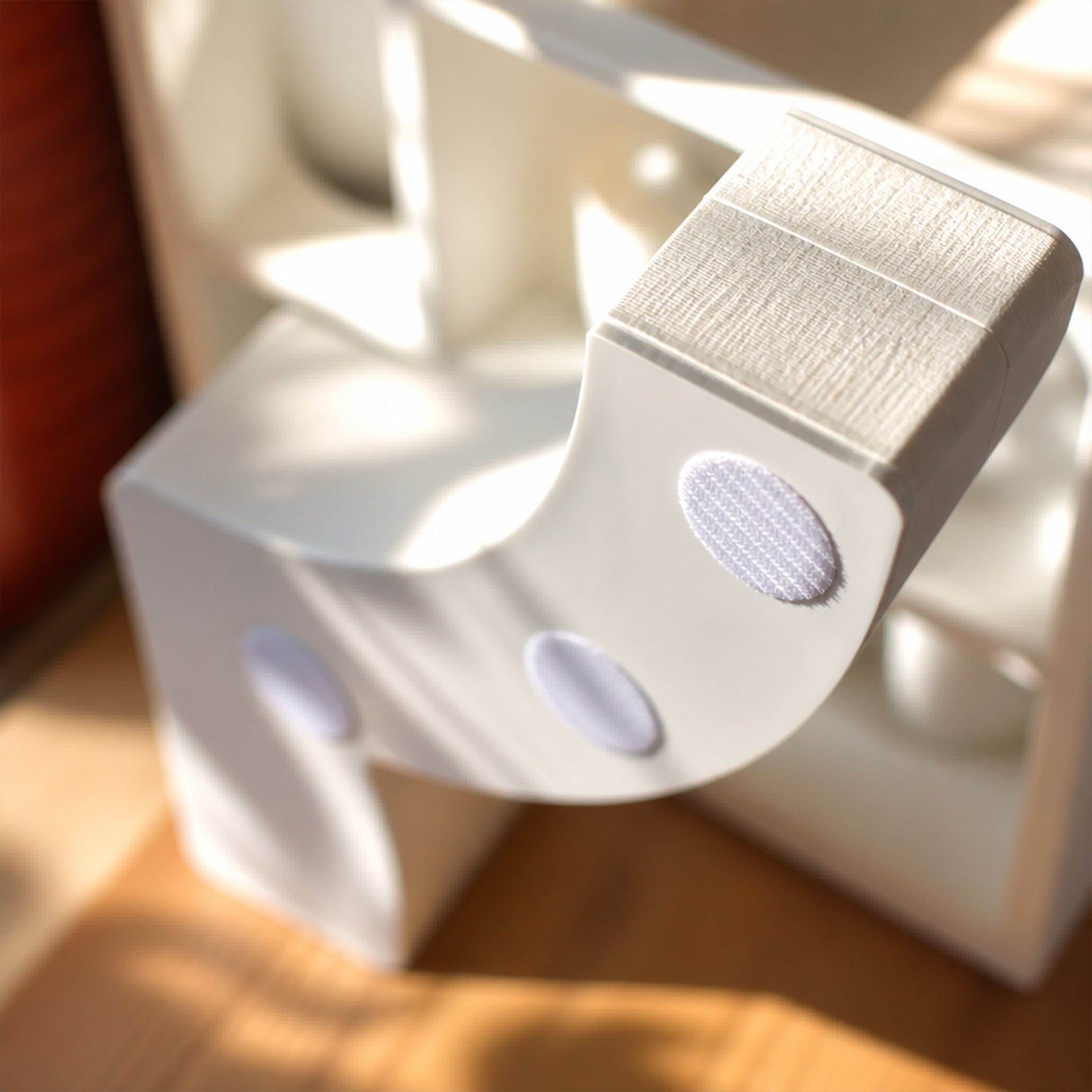 Close-up of the white Bouquet Side Table A acrylic side panel and Velcro fastening system.