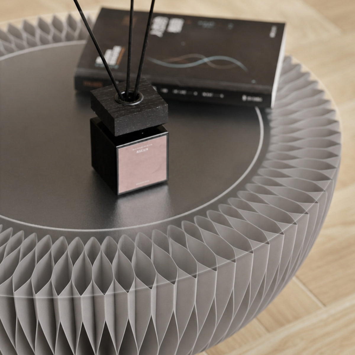 Light grey Bouquet Side Table B with an acrylic tabletop, books and fragrance diffuser.