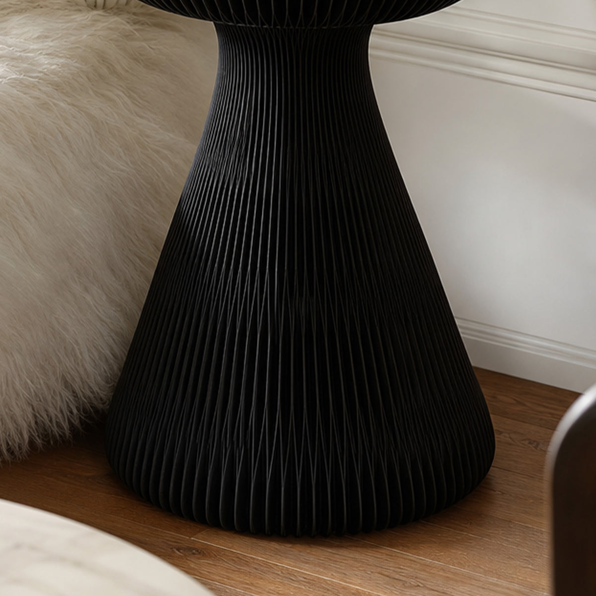 Close-up of the black Little Black Dress Side Table showing its sculptural folded honeycomb paper base