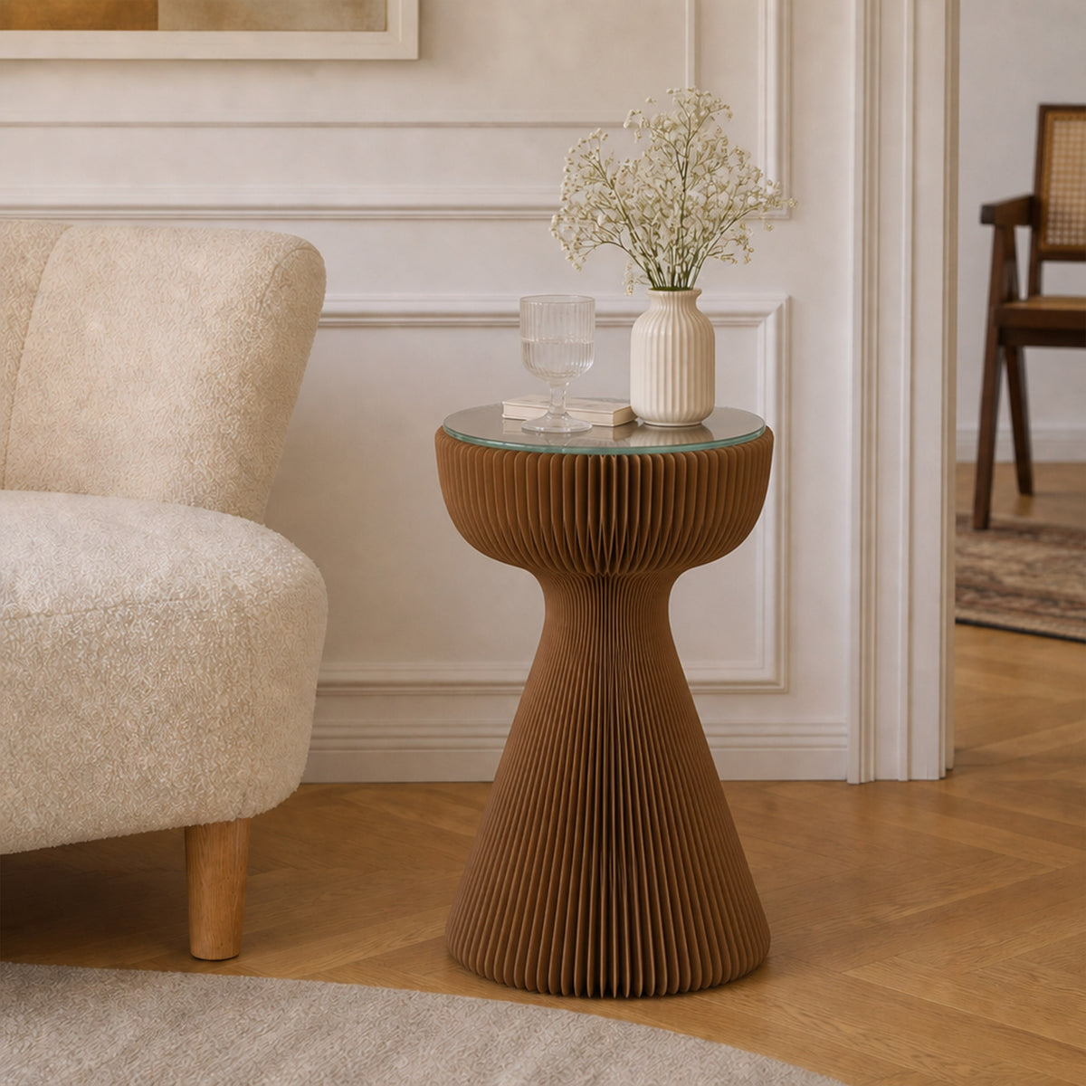 Brown Little Black Dress Side Table with glass tabletop styled with a flower vase and glass beside a cream lounge chair