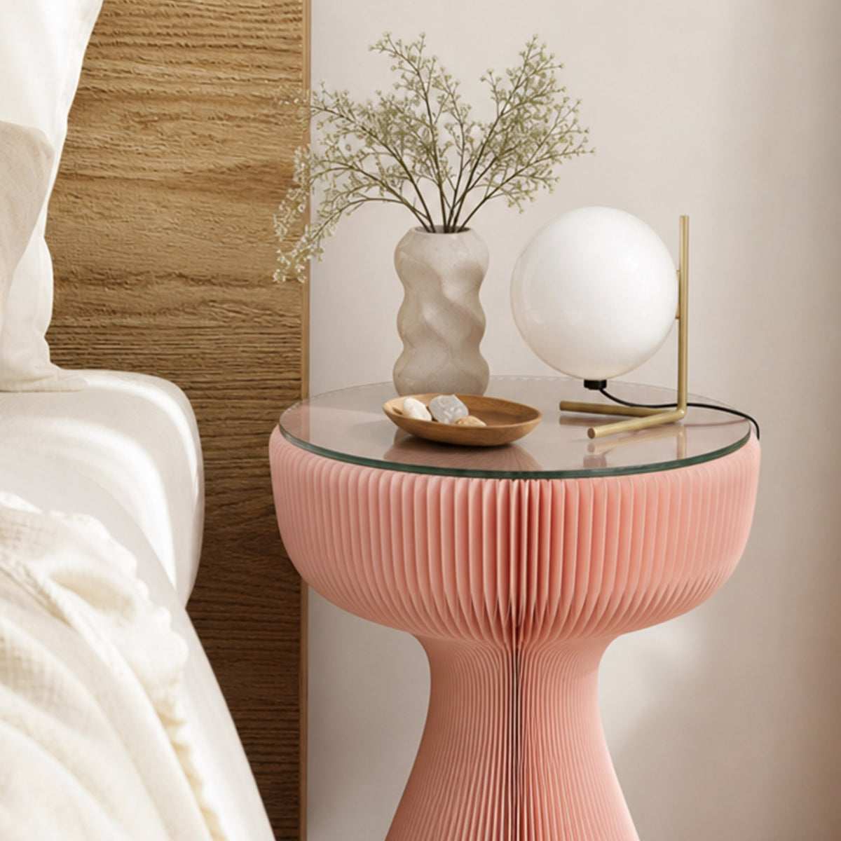 Pink Little Black Dress Side Table used beside a bed with a decorative lamp and vase on the tempered glass tabletop