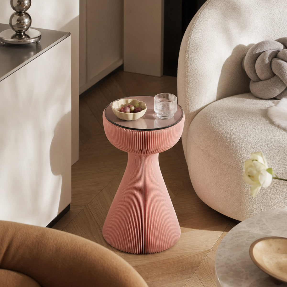 Pink Little Black Dress Side Table with glass top styled beside a curved cream sofa in a modern living room