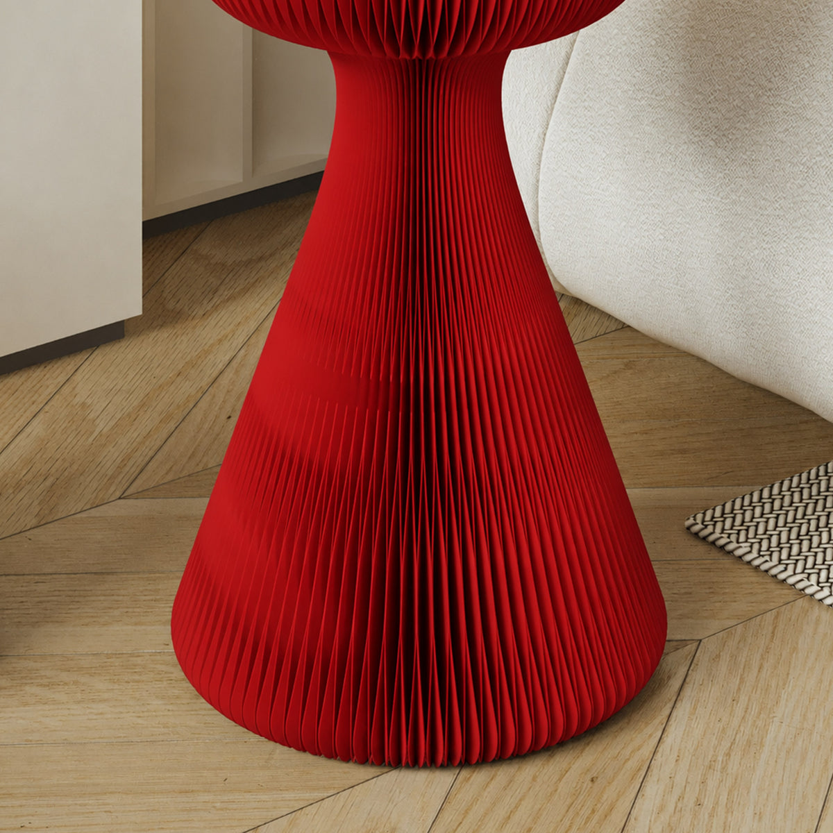 Close-up of the red Little Black Dress Side Table showing its pleated honeycomb paper structure and sculptural waist