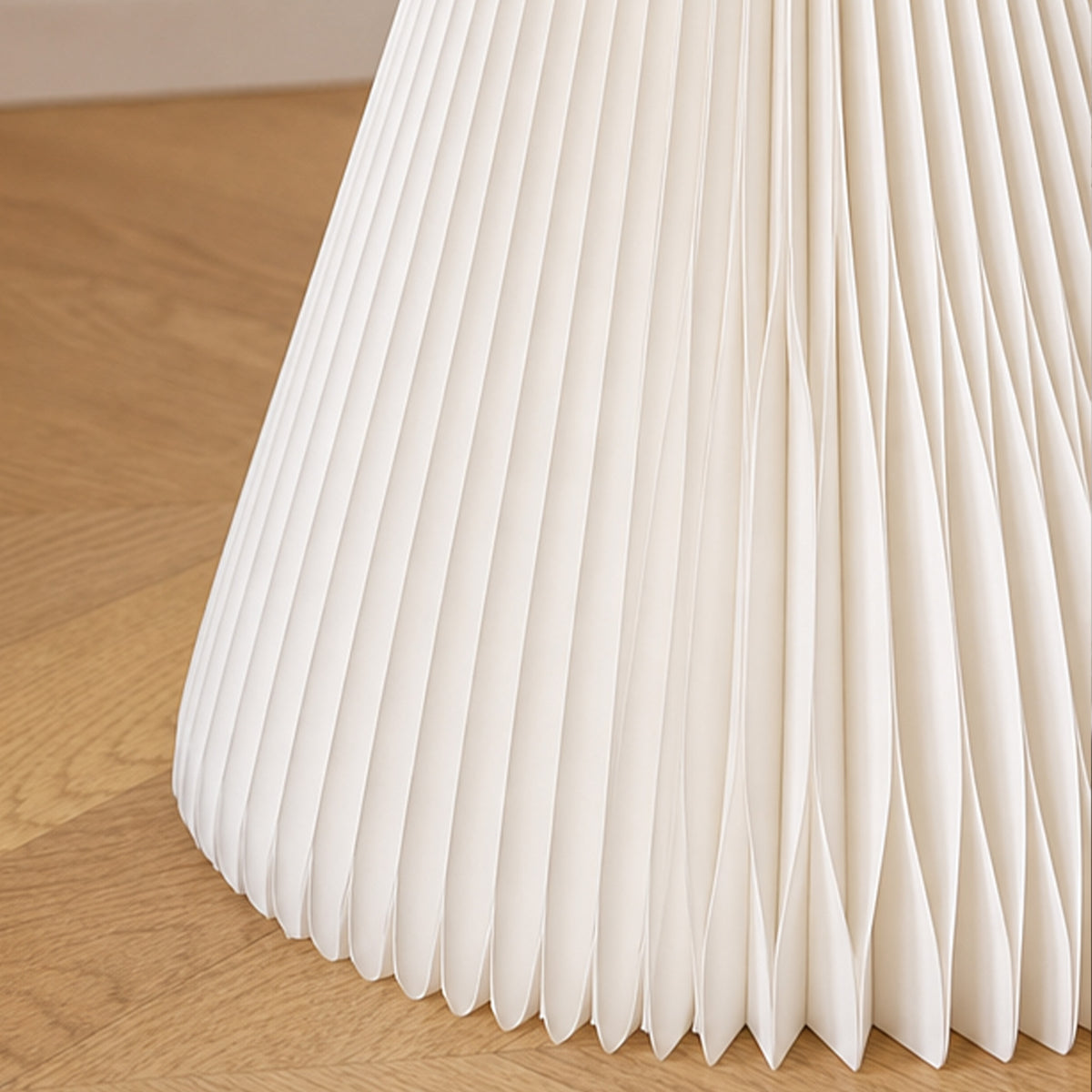 Detail of the white Little Black Dress Side Table showing the pleated foldable honeycomb paper structure