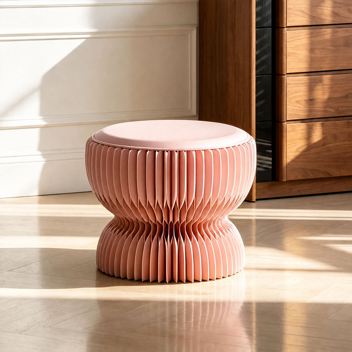 Pink LOTUS Stool A with foldable honeycomb paper structure and PU leather cushion in a warm modern living space