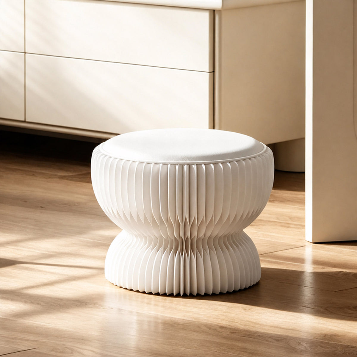 White LOTUS Stool A with foldable honeycomb paper structure and PU leather cushion in a sunlit modern interior