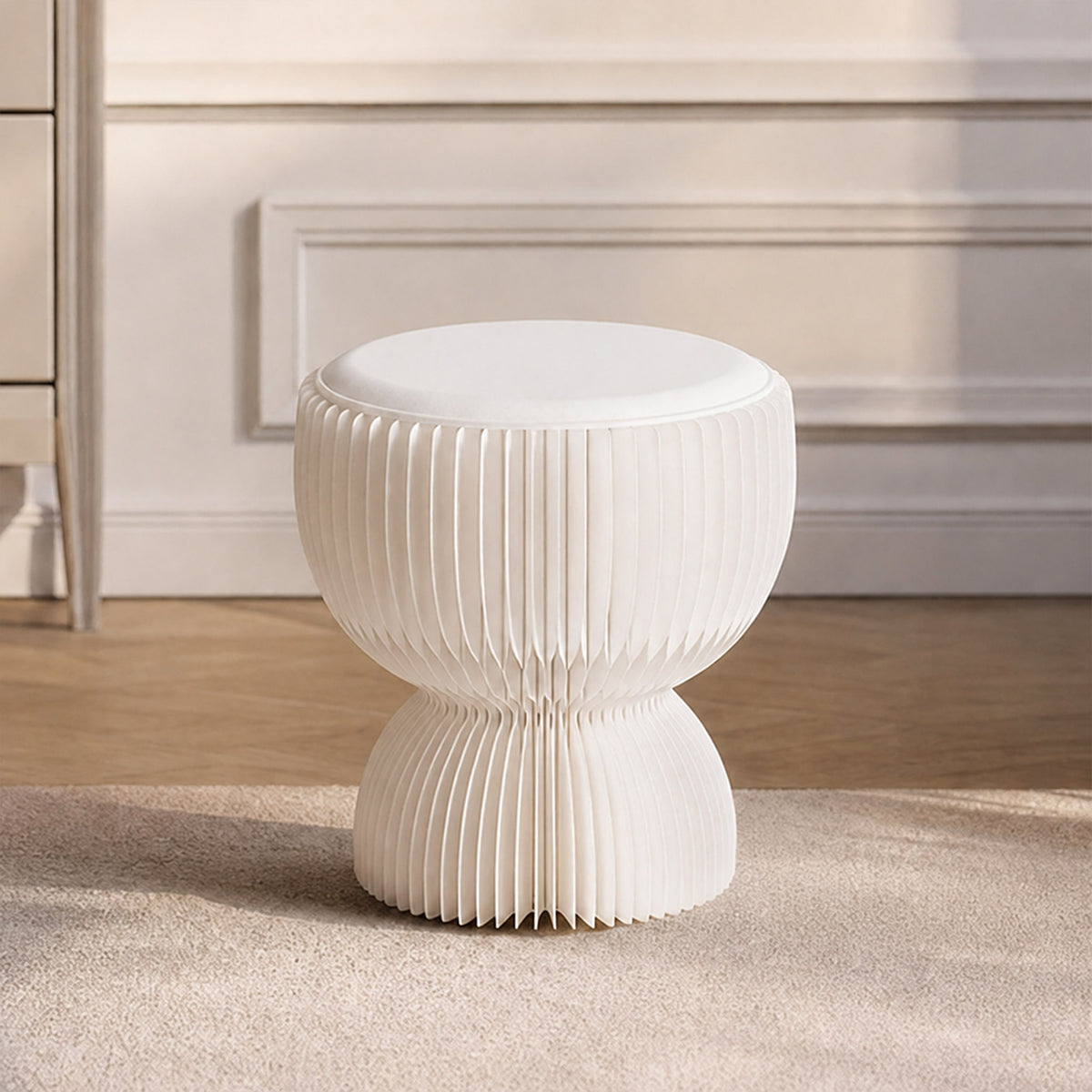 Front view of the white LOTUS Stool B, a sculptural foldable stool with honeycomb paper structure and PU cushion
