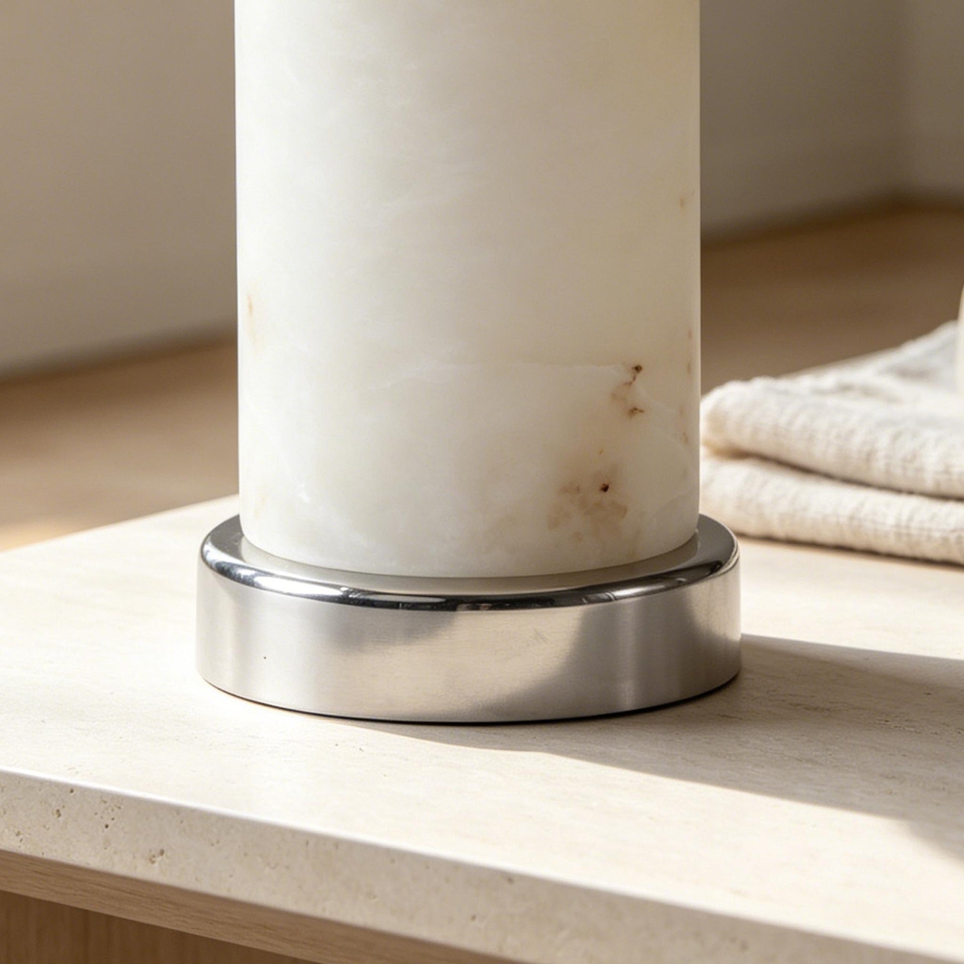 Close-up of the rechargeable marble table lamp base with natural stone texture and polished metal fitting.