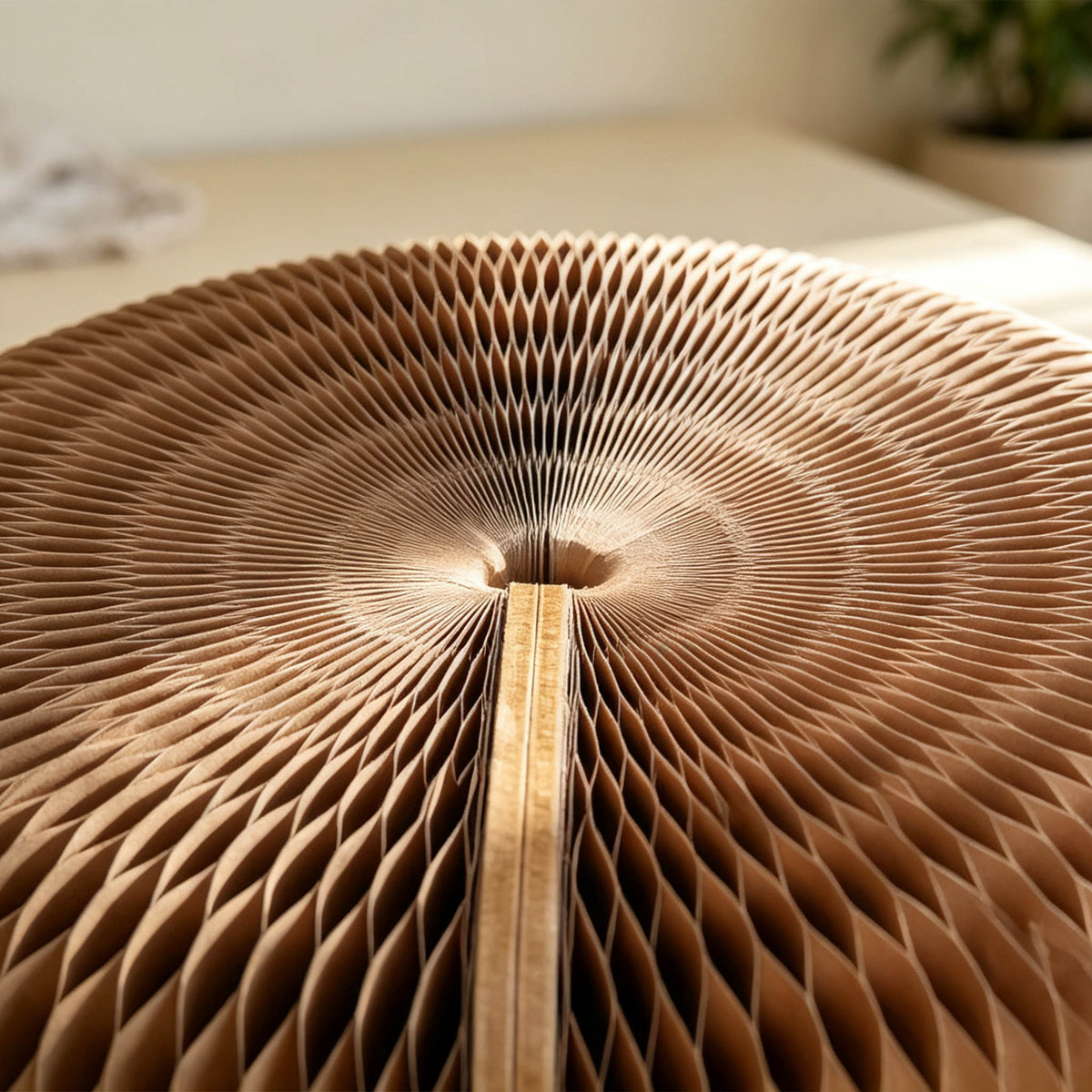 Close-up of the brown Meditation Cushion showing its expandable honeycomb paper structure and layered paper cells