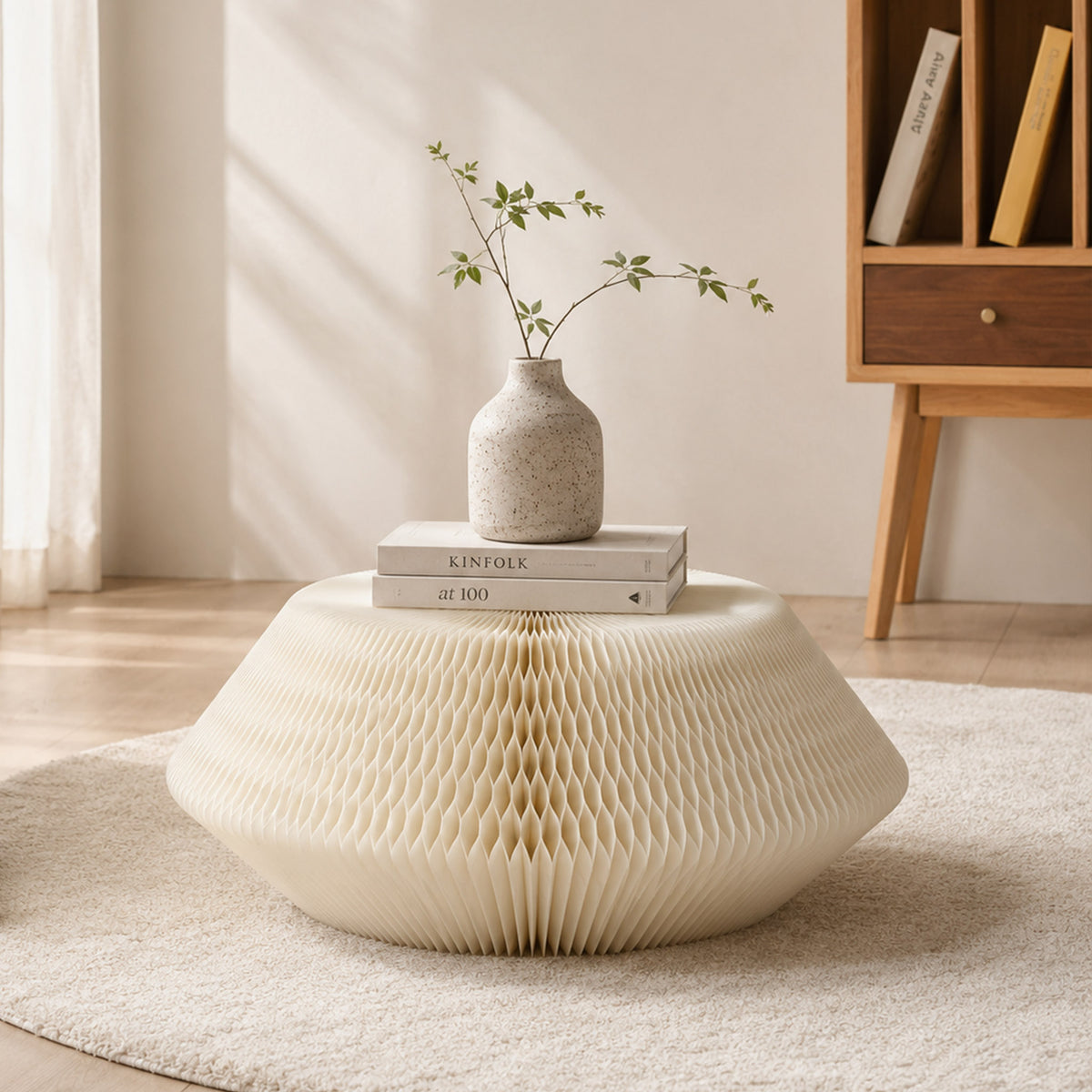 White honeycomb paper Meditation Cushion styled with books and a ceramic vase in a warm reading corner