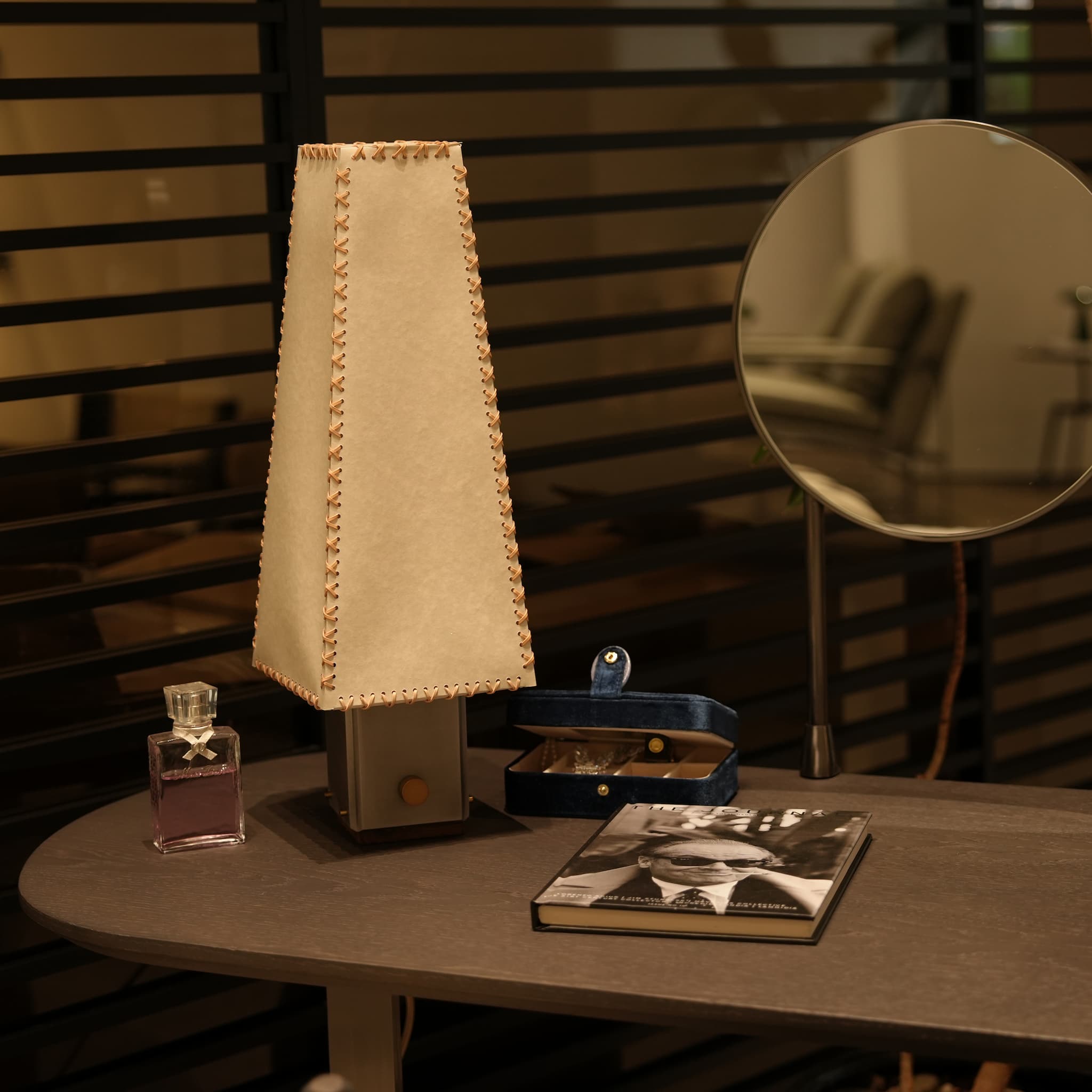 Handmade parchment table lamp styling on a modern minimalist vanity dresser.