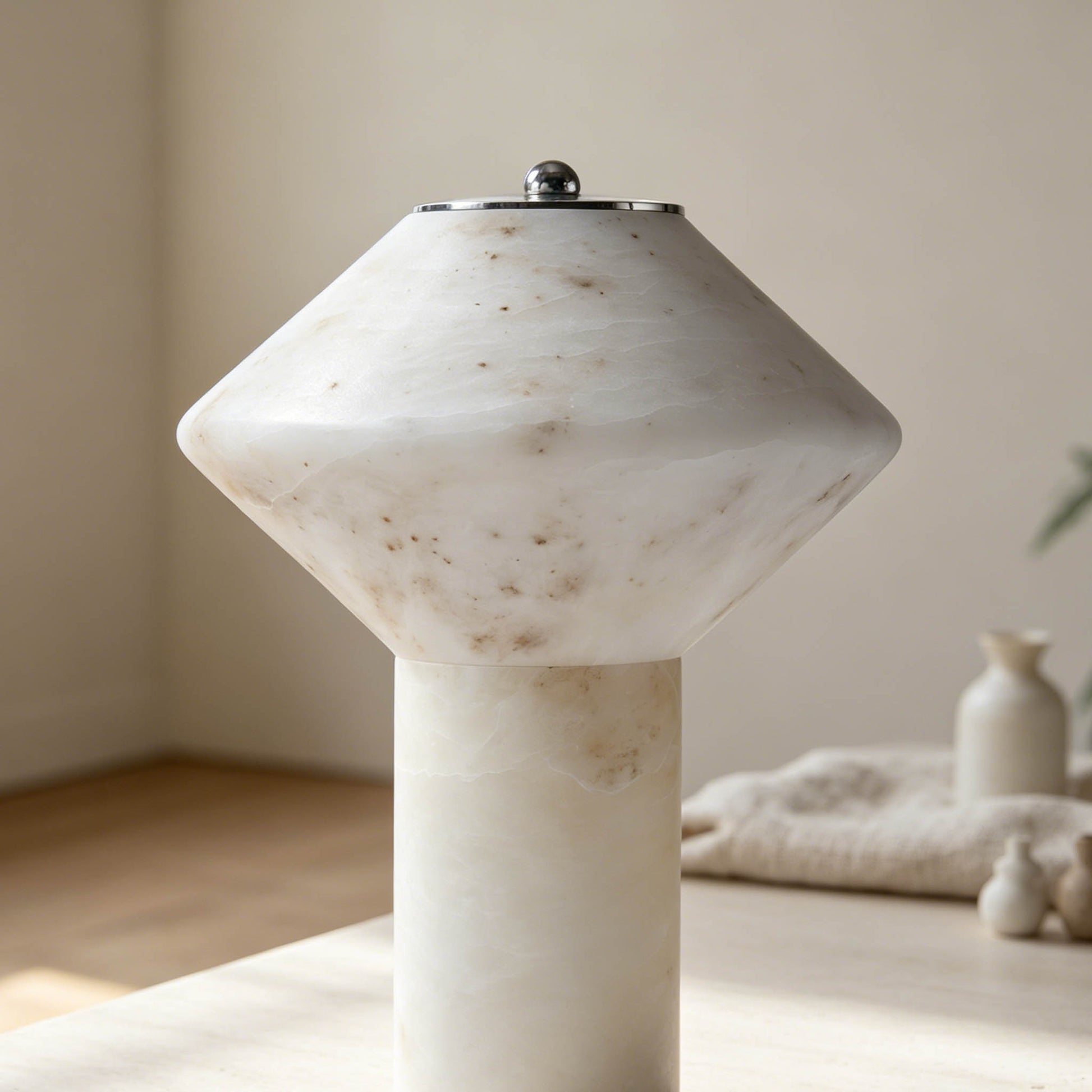 Rechargeable marble table lamp showing its natural stone shade, cylindrical body, and refined metal base.