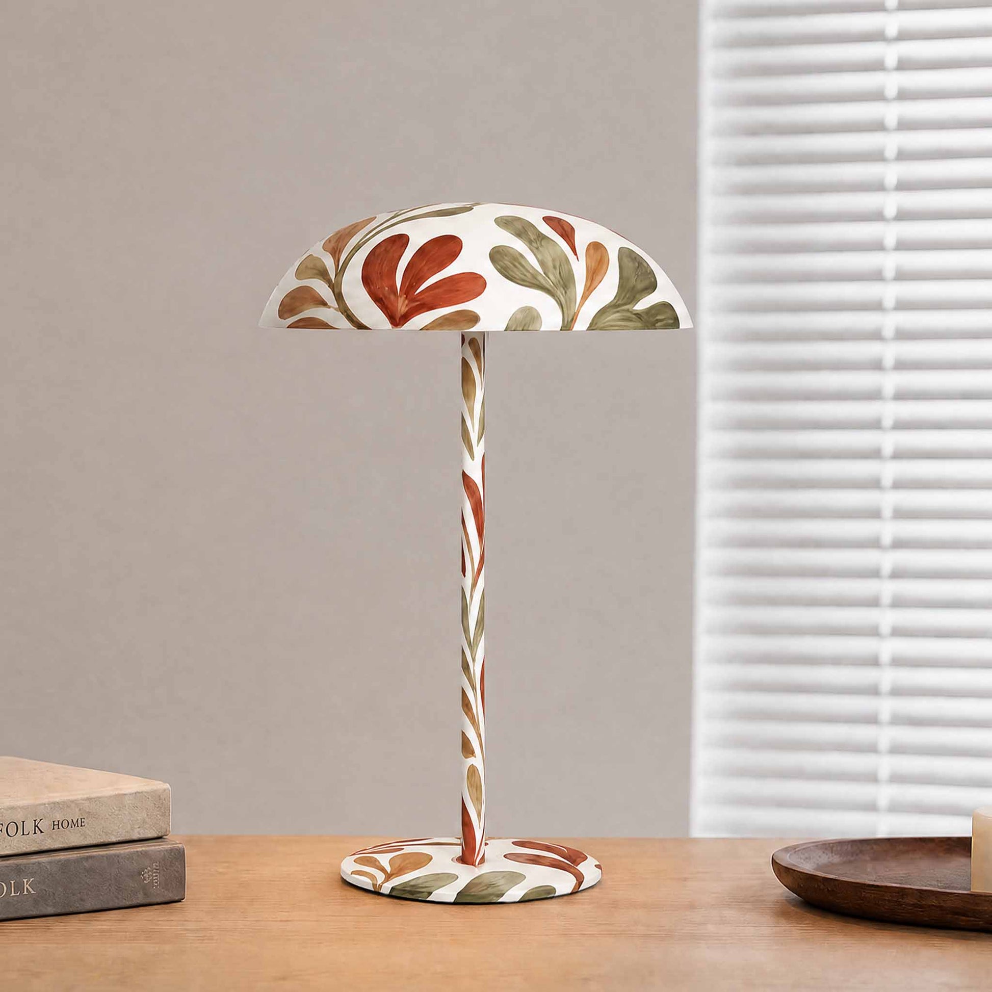 White botanical painted table lamp on a wooden console, designed as artistic lighting for modern home decor.