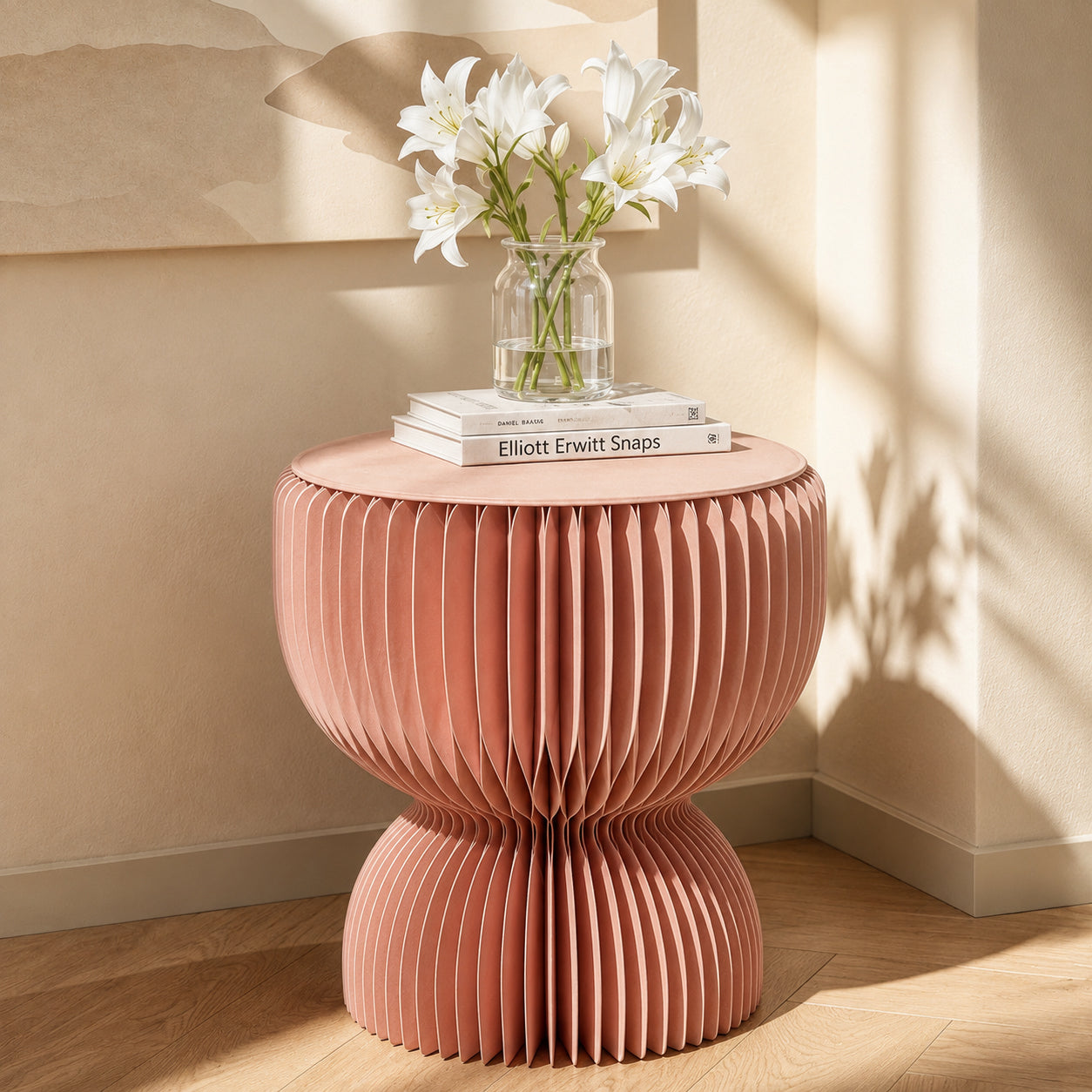Spaze Paper designer side table with a sculptural pink fluted form, styled with flowers and books in a sunlit interior.