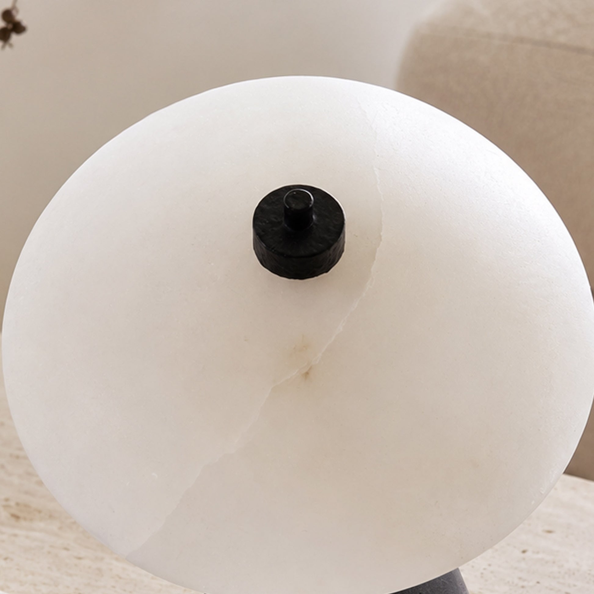 Close-up of the white natural marble lampshade showing soft veining and a black top detail.